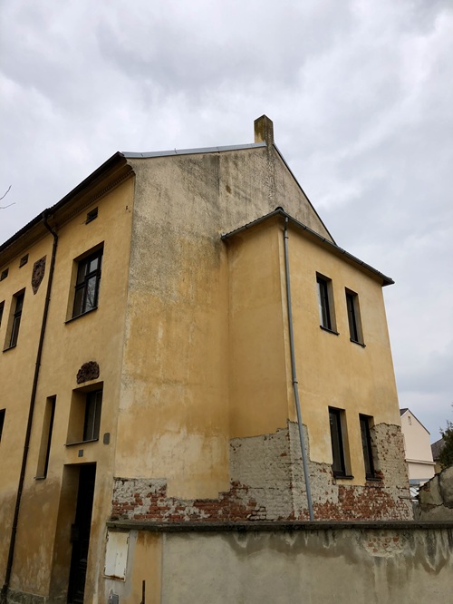 Původní stav fasády bytového domu před rekonstrukcí v obci Dívčice